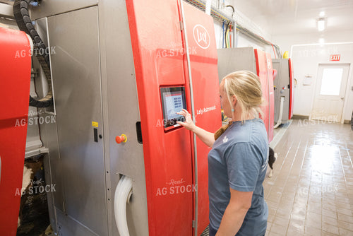 Farmer Adjusting Robotic Milking Unit 270206
