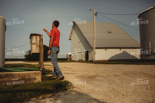 Farmer Checking Rain Gauge 4445