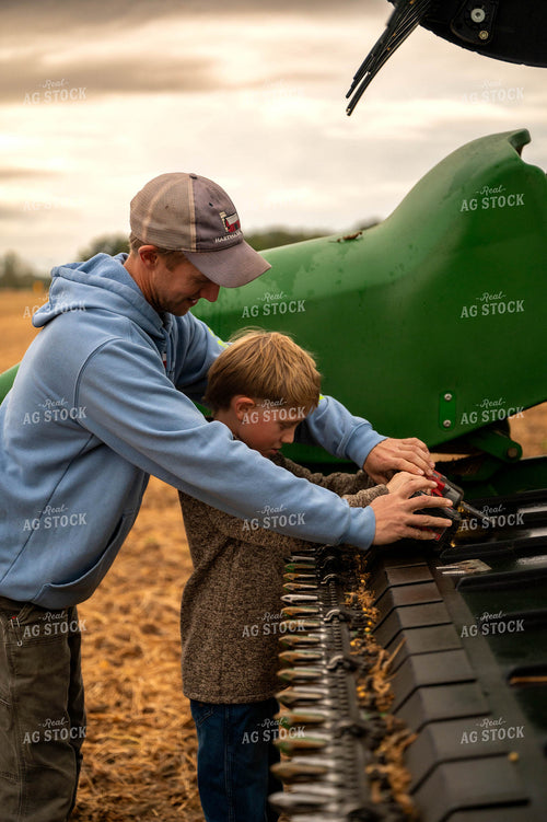 Farmer and Son Fixing Combine Head 115404