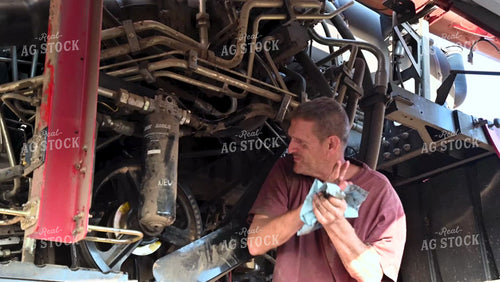 Farmer Repairing Combine - 429