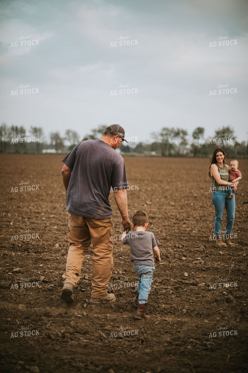 Farm Family in Field During Planting 5693