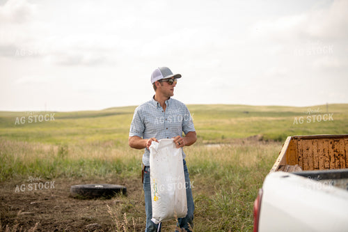 Rancher Giving Mineral to Cattle 212049