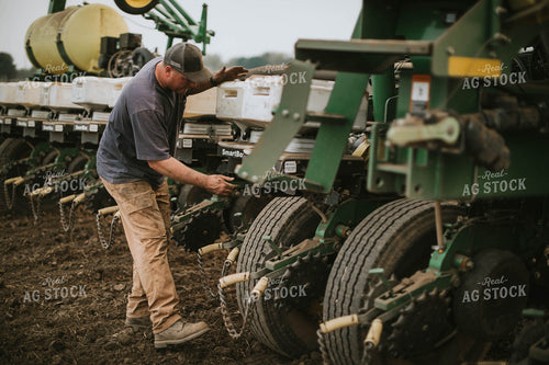 Farmer Adjusting Planter 5691