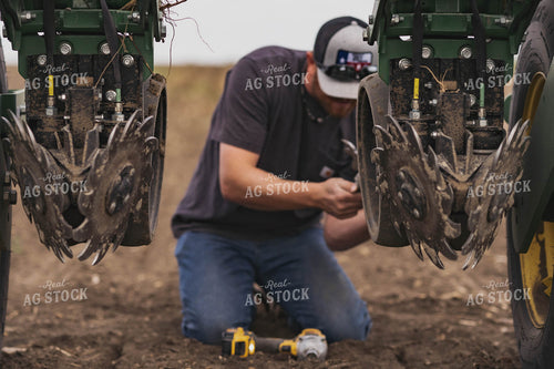 Farmer Repairing Planter 91010
