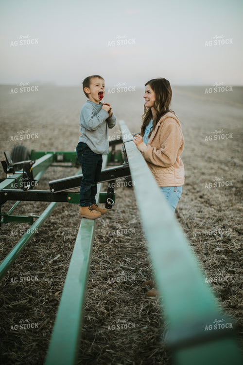 Farm Mom and Son Standing on Trailer 6760