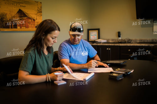 Husband and Wife Farmers Going Over Paperwork 6177