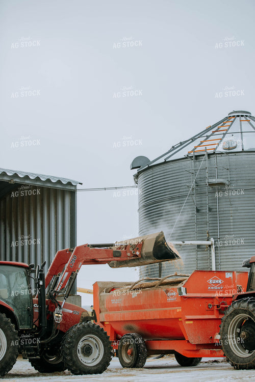 Tractor Emptying into feed mixer 77141