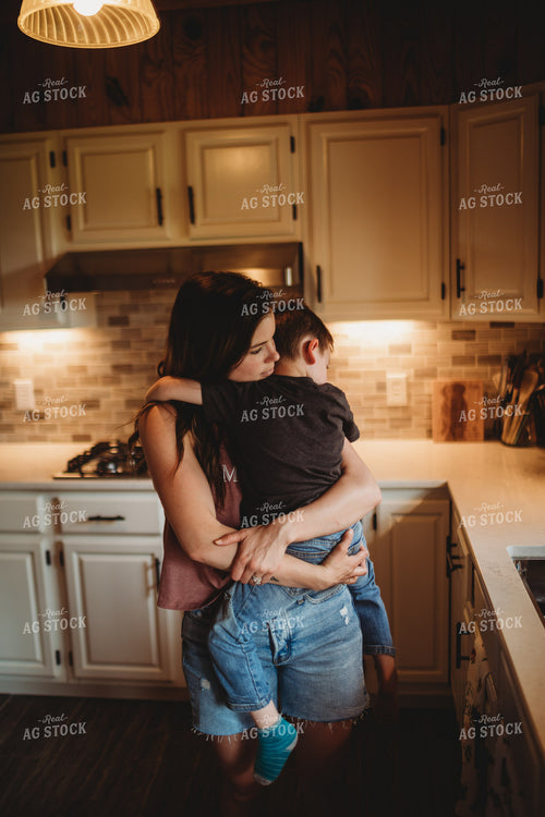 Farm Mom Hugging Farm Kid in Kitchen 5566