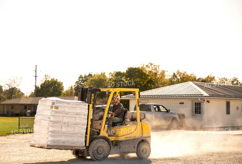 Farmer Carrying Bags on Skid Steer 115524