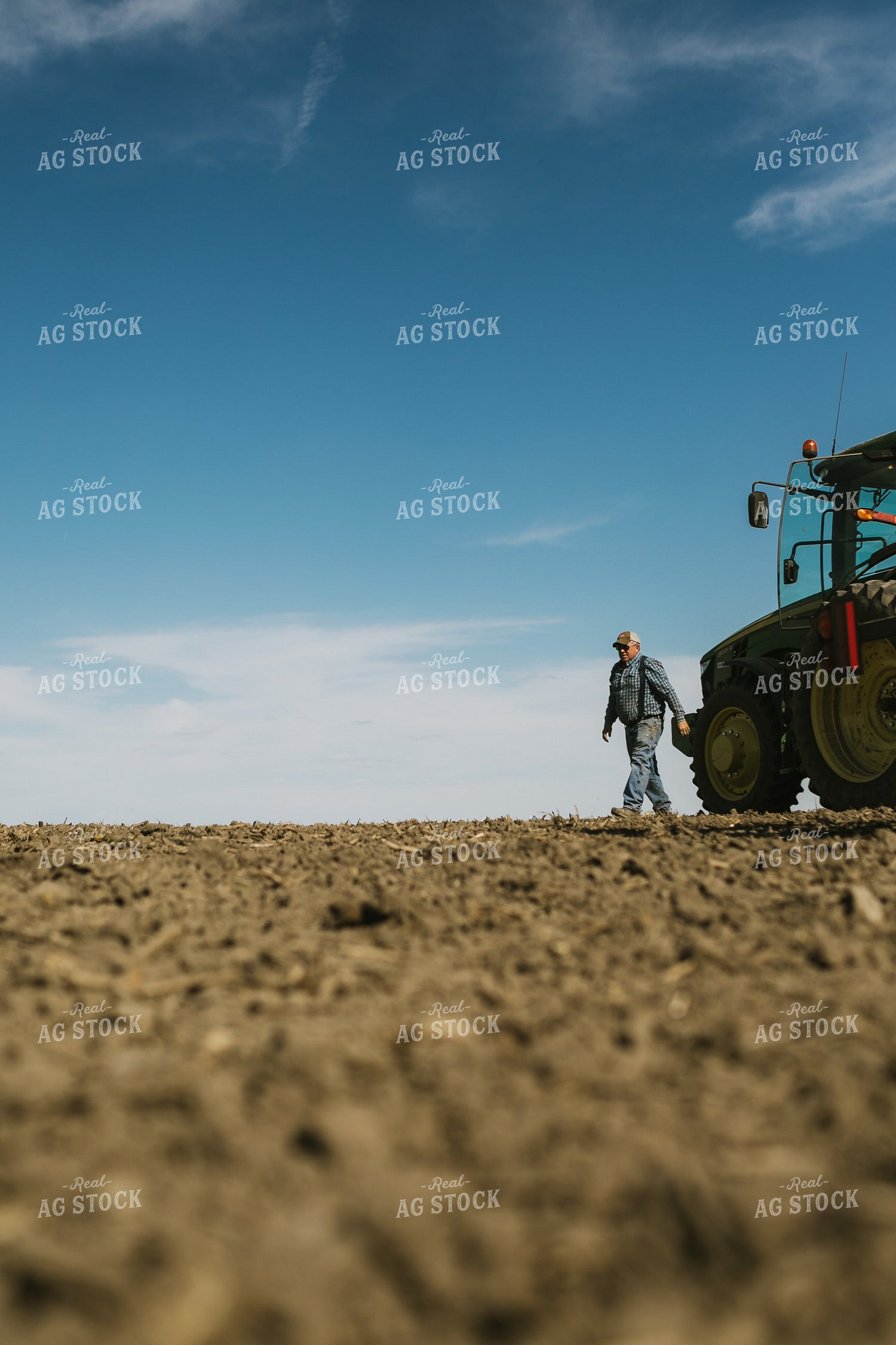 Farmer Climbing out of Tractor with Planter 4102