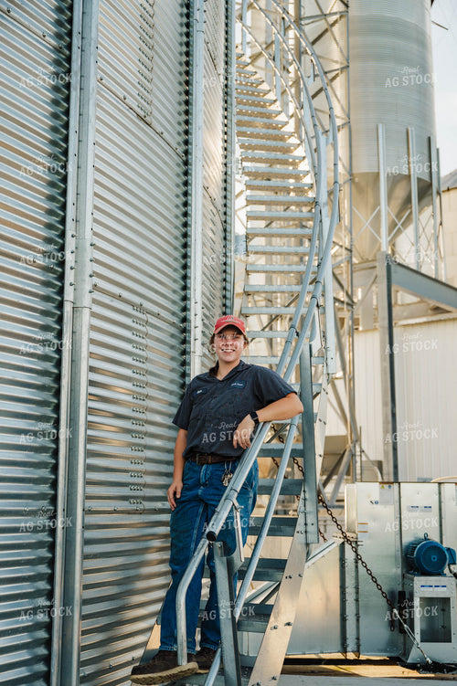 Female Farmer Climbing Grain Bin 115271