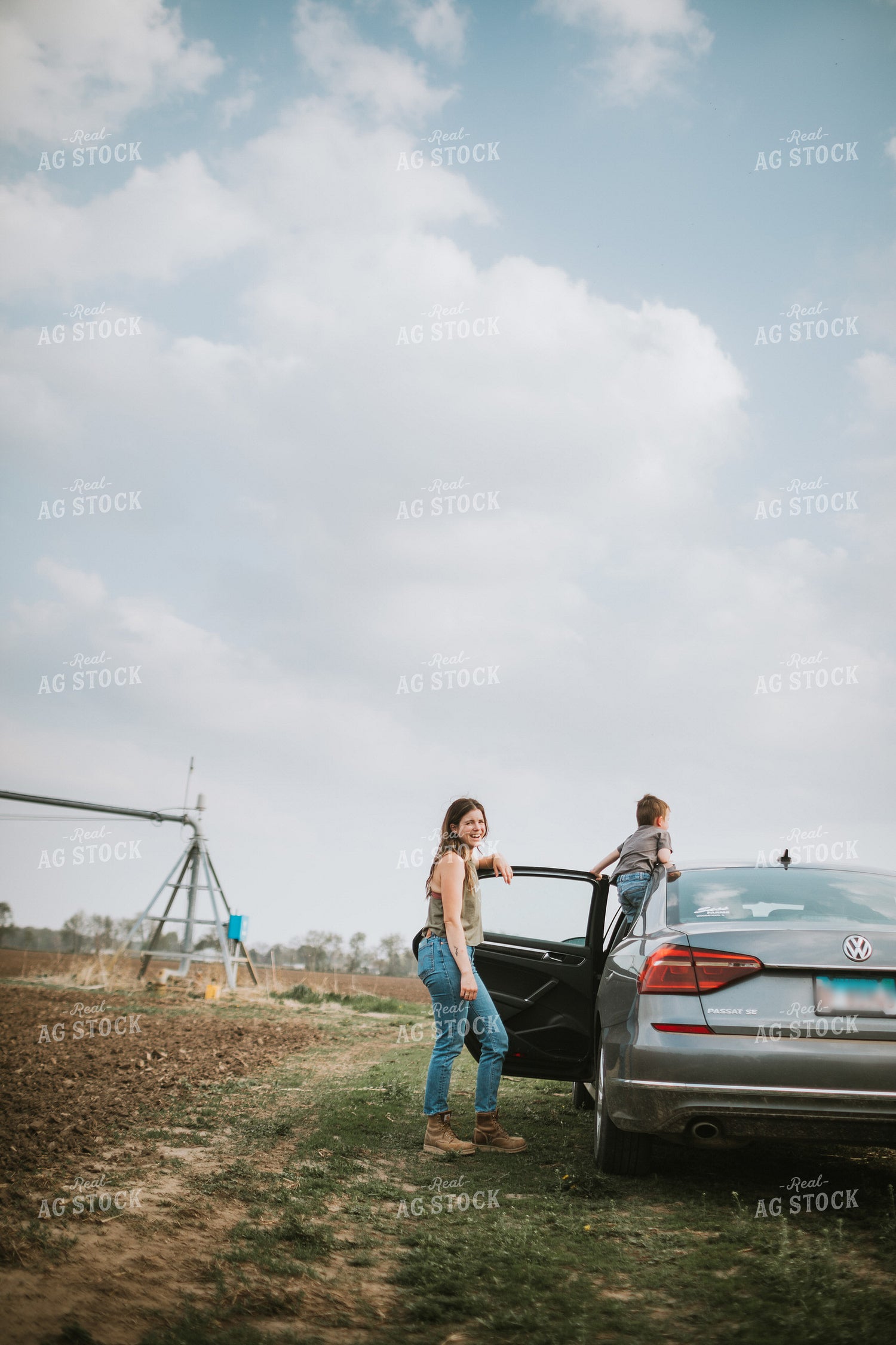 Farm Mom and Kid Arriving at Field During Planting 5599