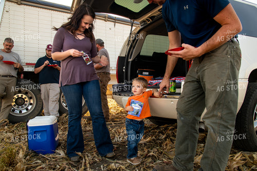 Family Enjoying Harvest Meal in the Field 25810