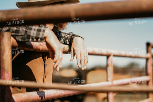 Rancher Leaning Against Gate 64038