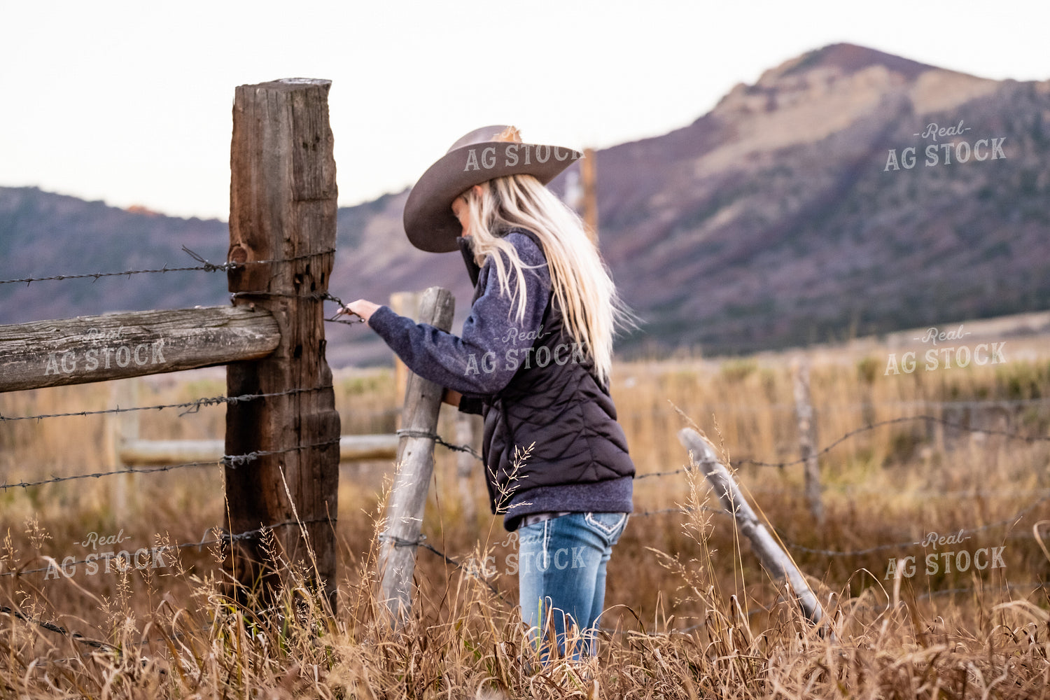 Female Rancher Fixing Fence 163003