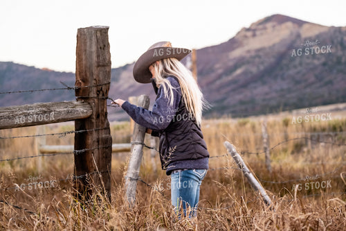 Female Rancher Fixing Fence 163003