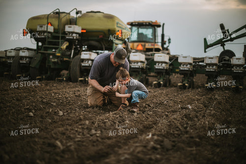 Farmer and Farm Kid Checking Seed Depth 5652