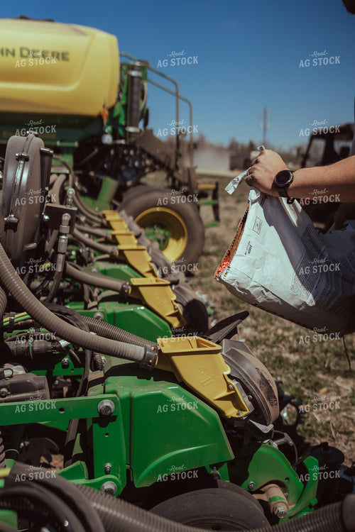 Farmer Filling Planter for Test Plot 196112