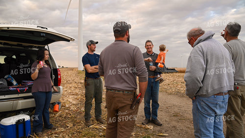 Family Enjoying Harvest Meal in the Field 25776