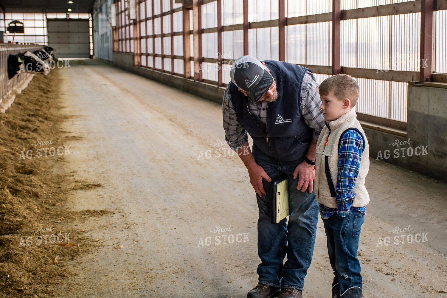 Farmer and Farm Kid in Dairy Barn Alley 271035