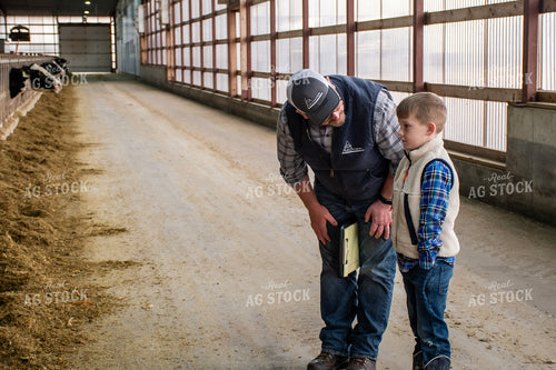 Farmer and Farm Kid in Dairy Barn Alley 271035