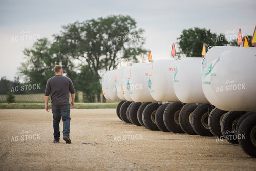 Retailer Walking by Anhydrous Tanks 7895