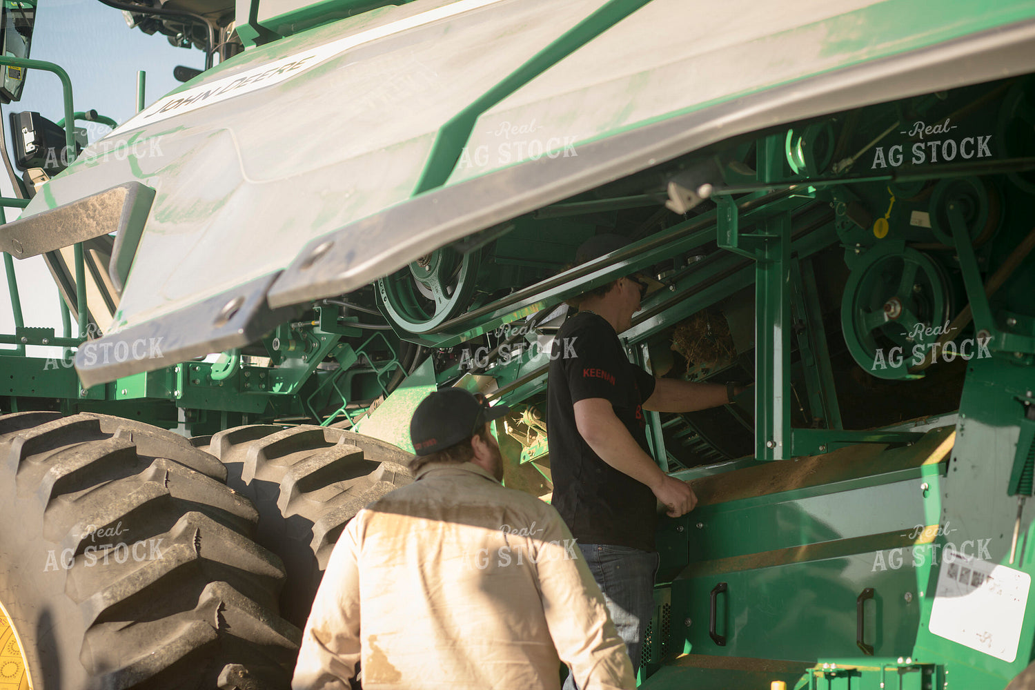 Farmers Working on Combine 135123