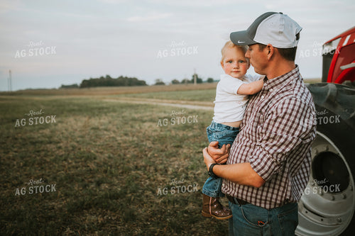 Farmer with Farm Kid Next to Tractor 4985