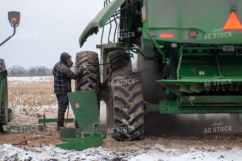Farmer Cleaning Combine 50462