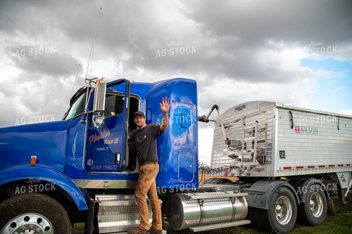 Farmer Climbing into Semi Cab and Waving 25540