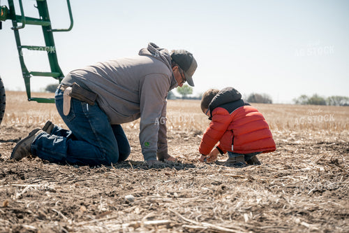 Farmer and Farm Kid Checking Seed Depth 65657