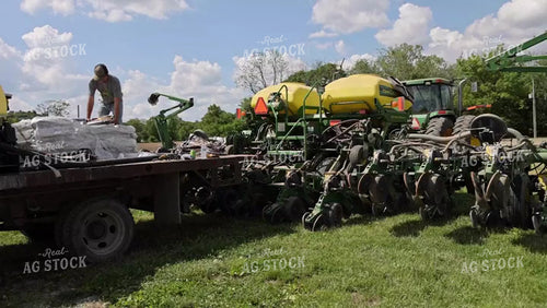 Farmer Loading Planter with Seed Bags 52451