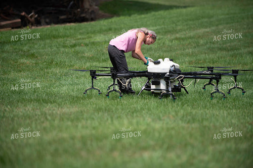 Female Pilot Preparing Drone for Fungicide Application 168073