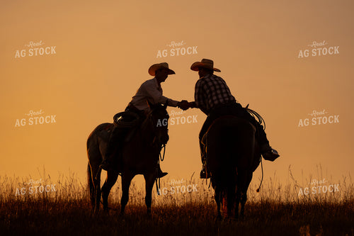 Ranchers Shaking Hands on Horseback 163000