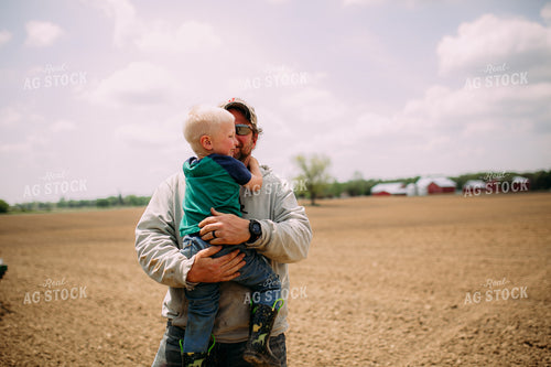 Farmer Helping Son Out of Tractor 169081