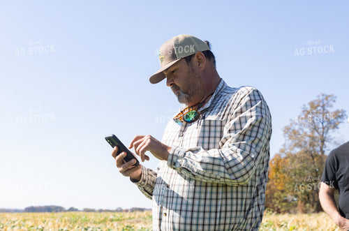 Farmer Looking at Phone 79841