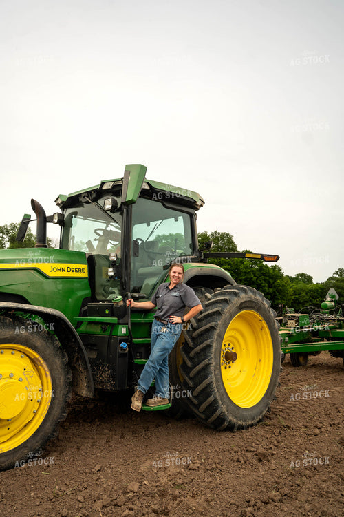 Female Farmer Climbing into Planter 115689