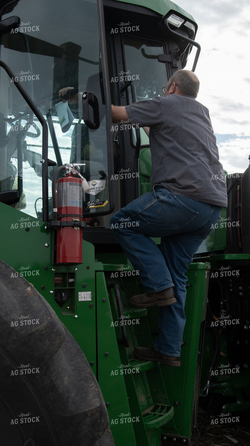 Farmer Climbing into Tractor 26148