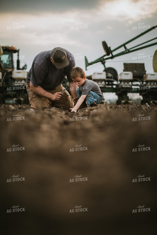Farmer and Farm Kid Checking Seed Depth 5657