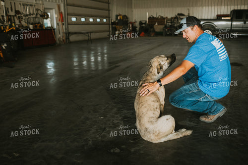 Farmer Petting Dog in Farm Shop 6200