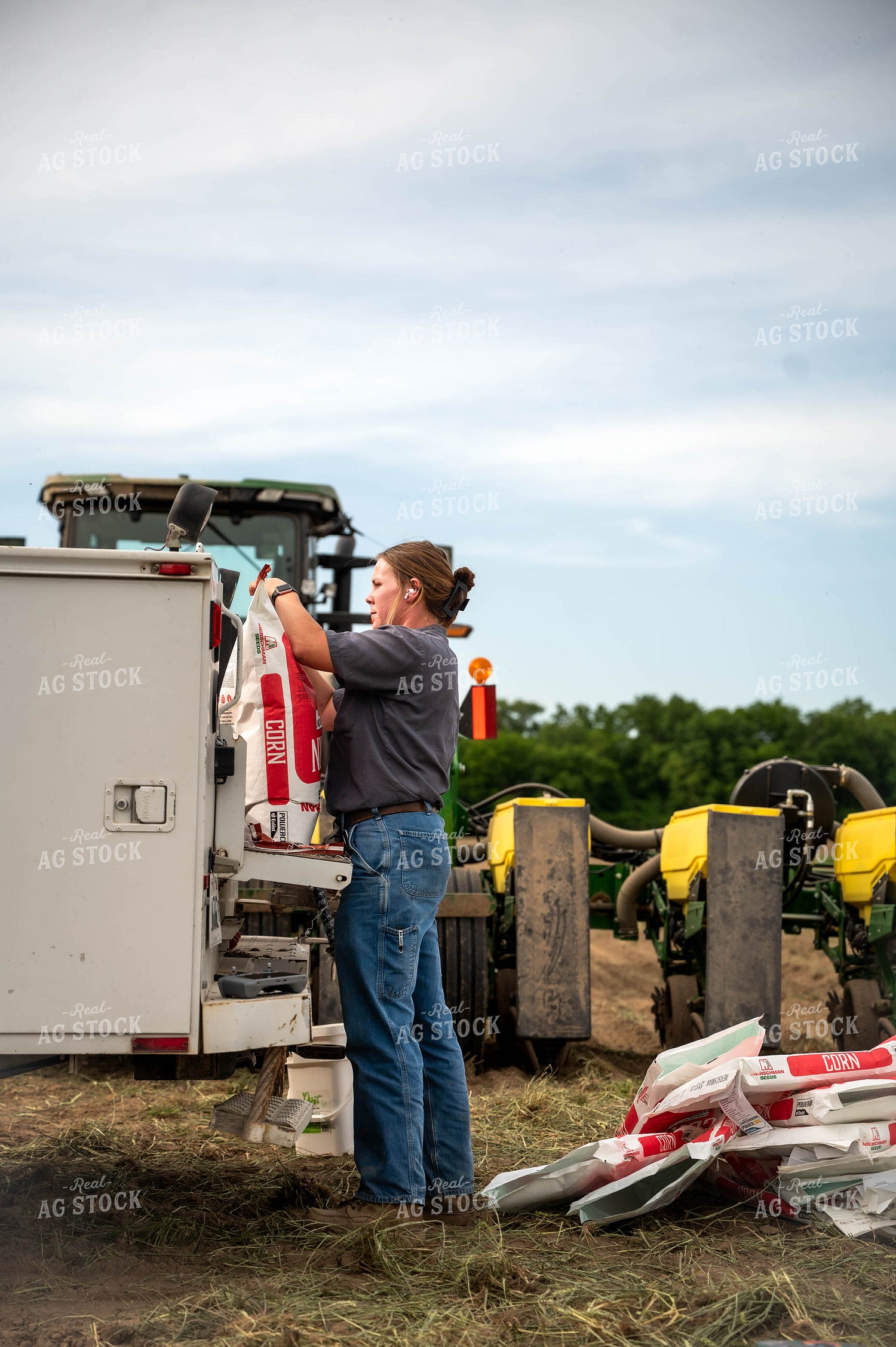 Female Farmer Filling Planter 115641