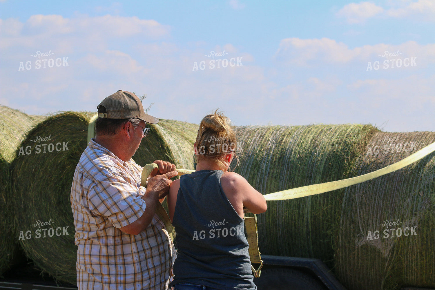 Farmers Securing Hay Bales 160323