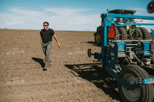 Farmer Climbing out of Tractor with Planter 4284
