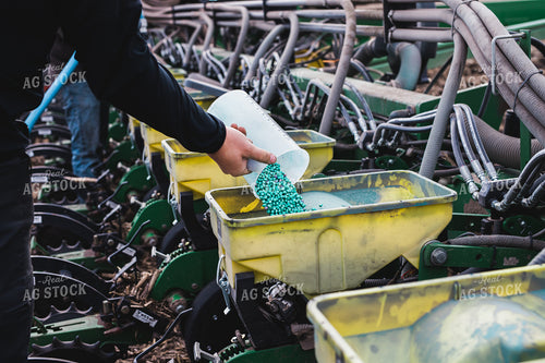Farmers Pours Seed into Planter 133006
