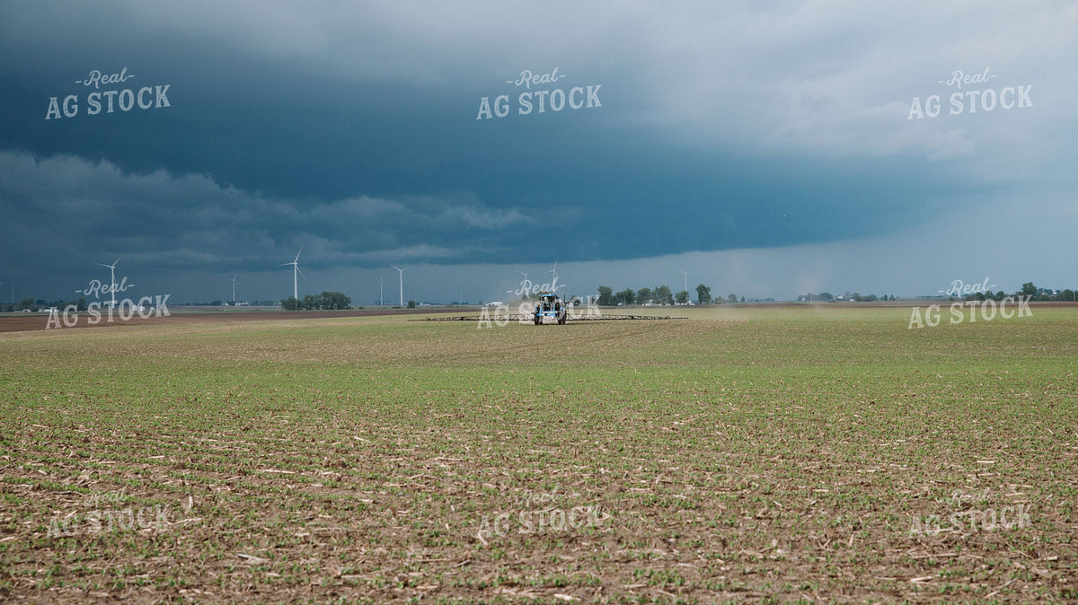 Self-Propelled Sprayer Applying Crop Protection Under Stormy Skies with Wind Turbines 401037