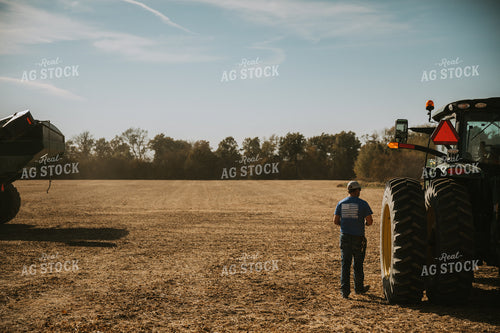 Farmer Walking Near Tractor 7077