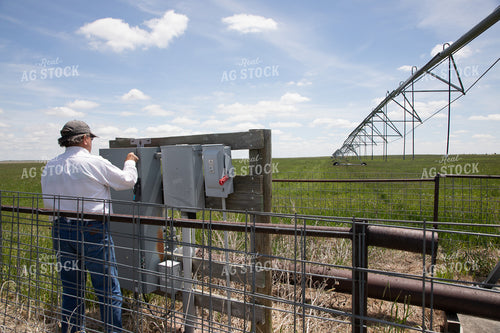 Farmer Checking Pivots 117054