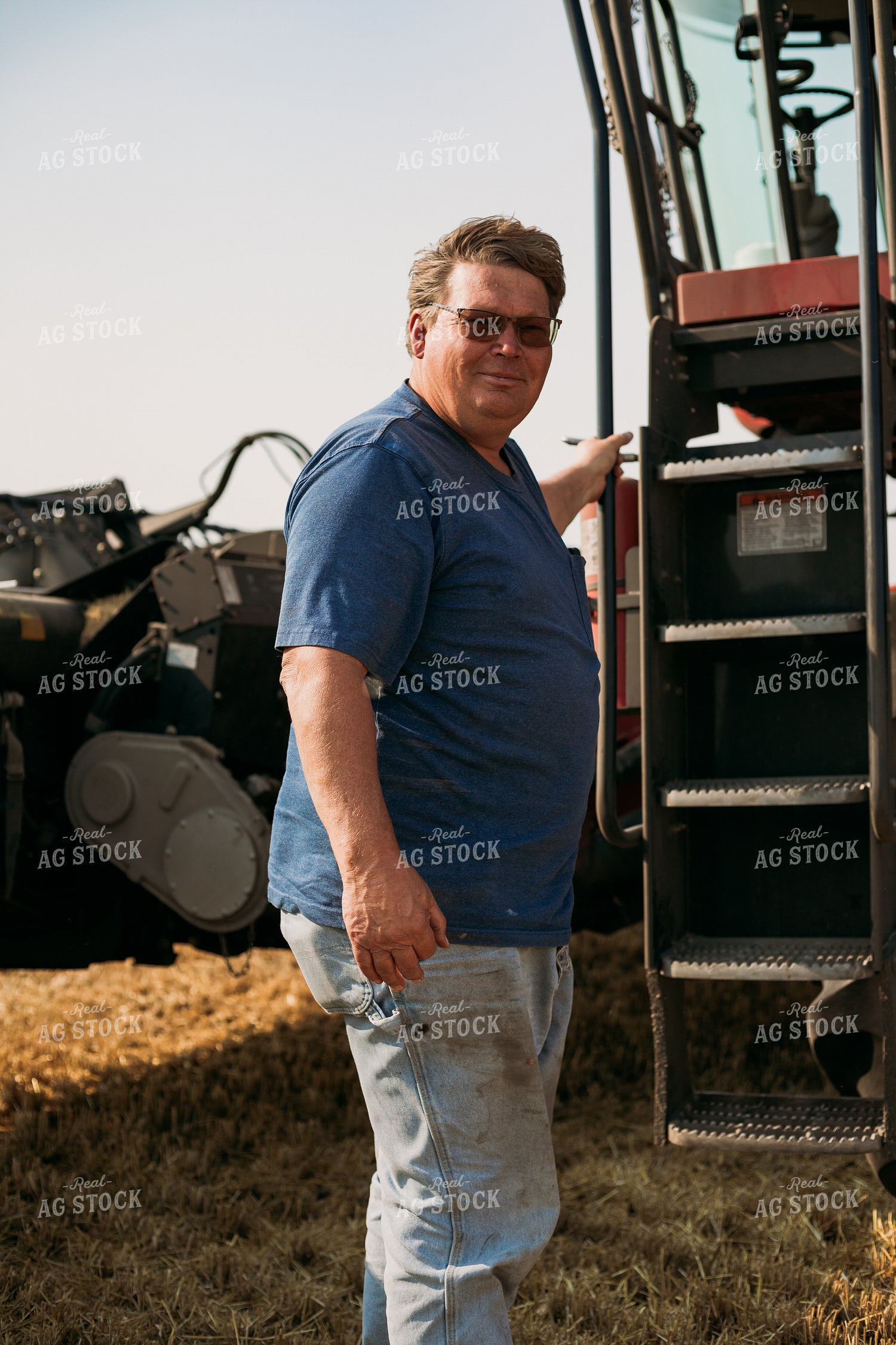 Farmer Standing by Combine 204016