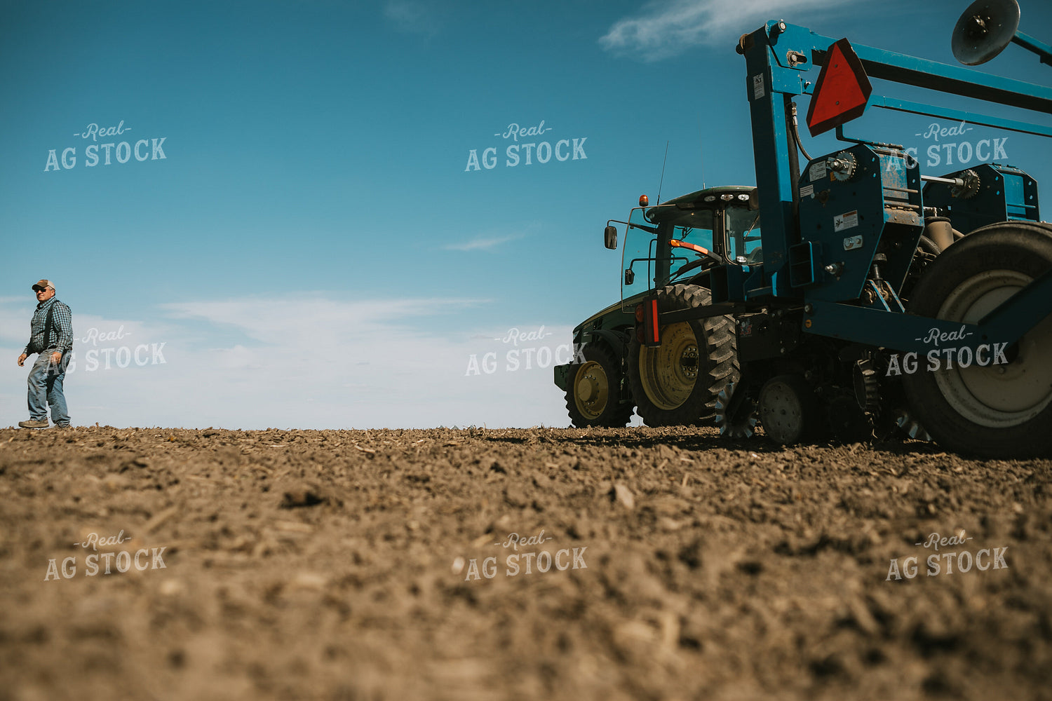 Farmer Climbing out of Tractor with Planter 4099