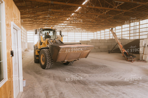 Tractor Loads Dry Feed in Storage Shed 7521